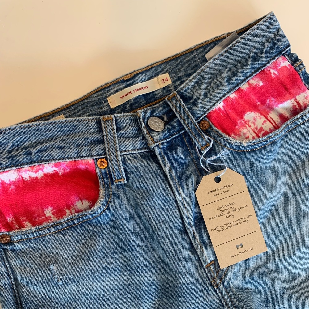 Denim levis jeans. With tie dye pocket decor.